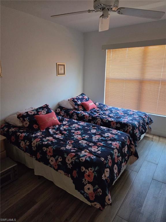Bedroom featuring dark wood finished floors and ceiling fan