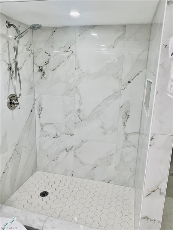 Bathroom with a marble finish shower