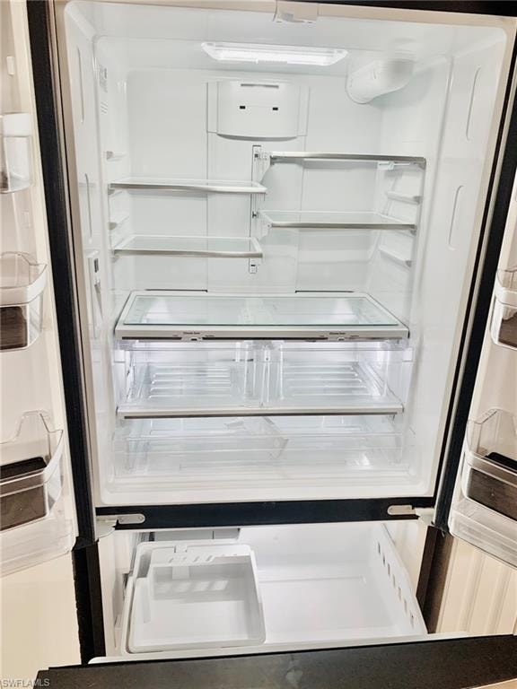 Kitchen view of white refrigerator