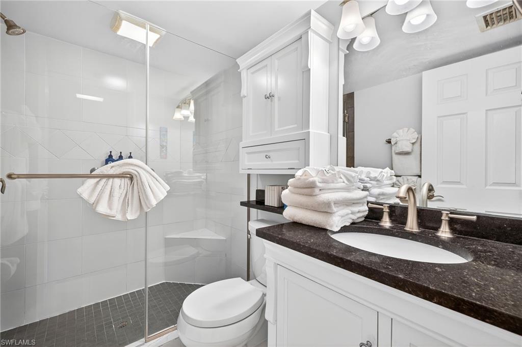 Bathroom featuring vanity and a shower stall