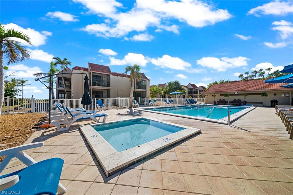Community pool featuring a patio and a hot tub