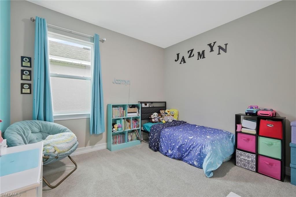 Bedroom with carpet flooring and baseboards