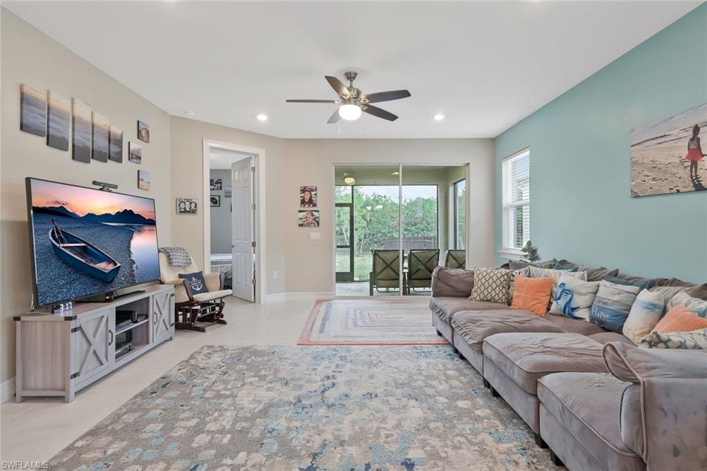 Living room with ceiling fan and recessed lighting
