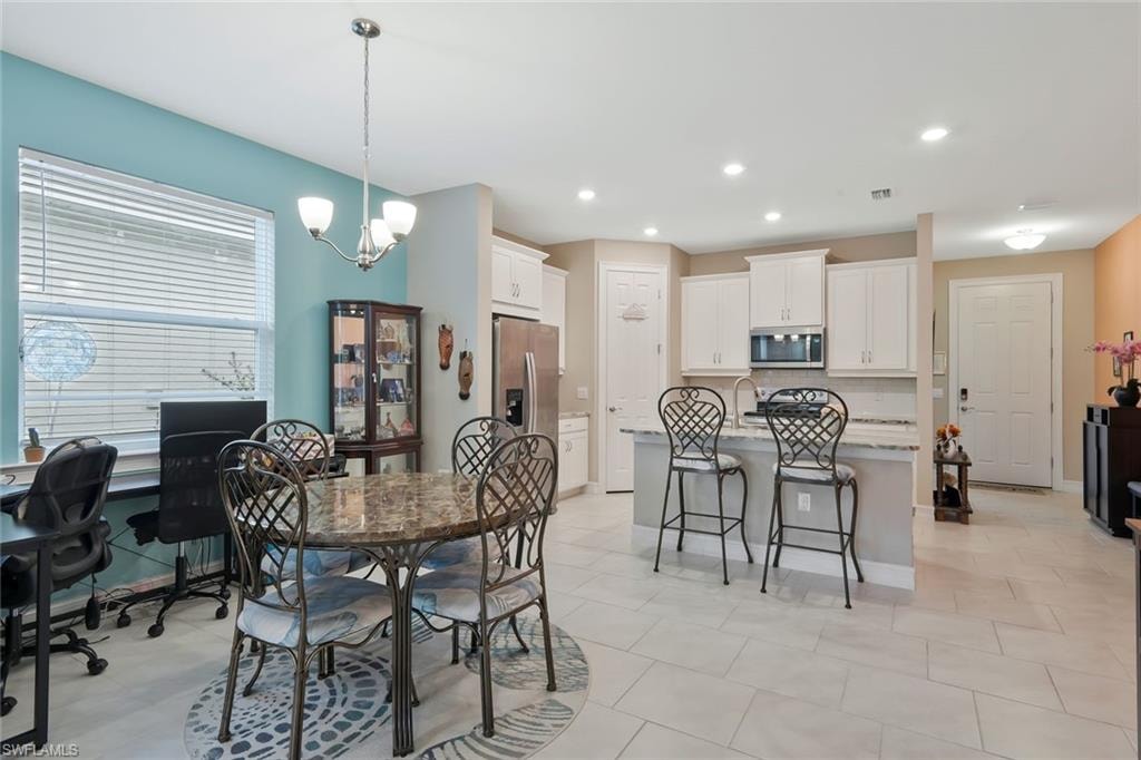 Dining area featuring a chandelier, recessed lighting, and a desk