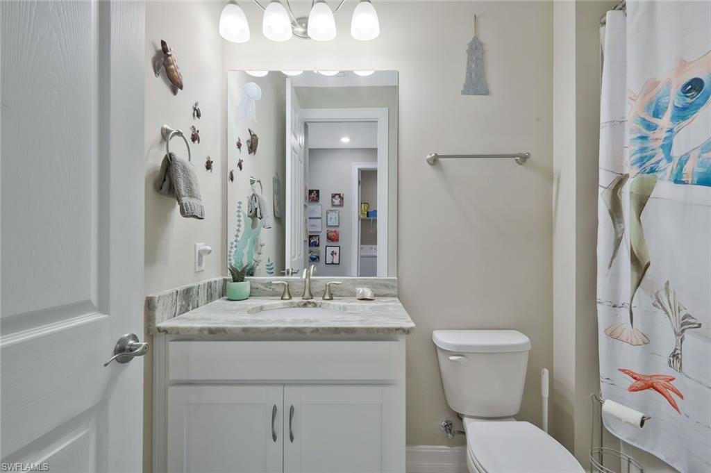 Full bathroom with a shower with shower curtain and vanity