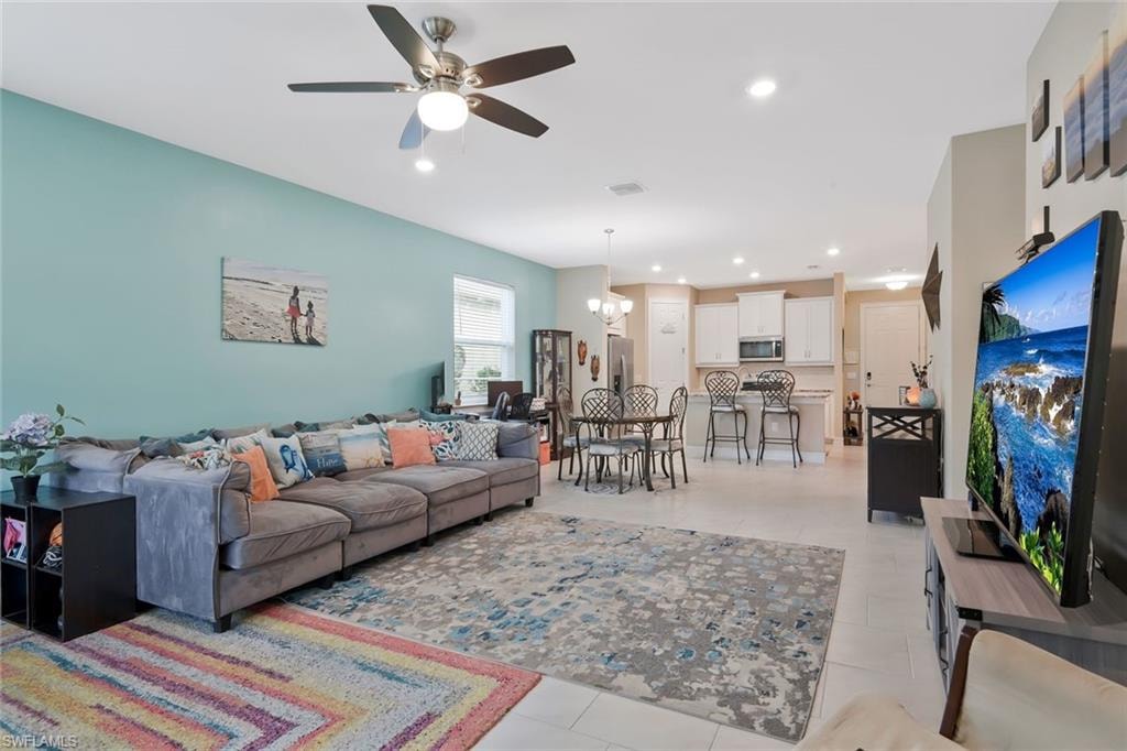 Living area with a chandelier, recessed lighting, and ceiling fan