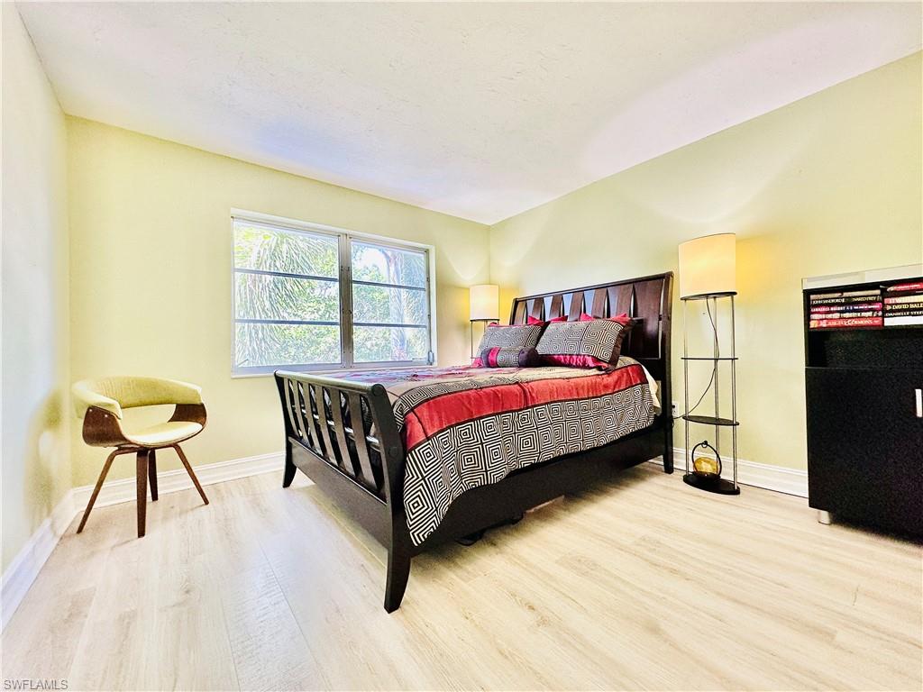 Bedroom featuring light wood-type flooring and baseboards