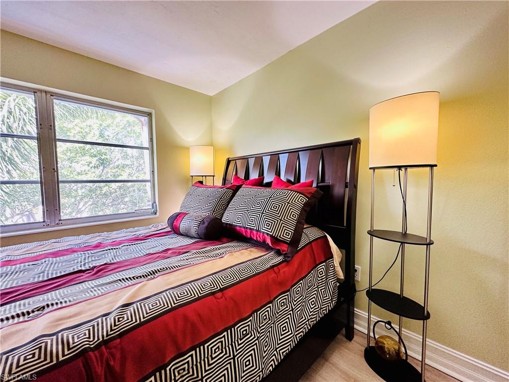 Bedroom with baseboards and wood finished floors