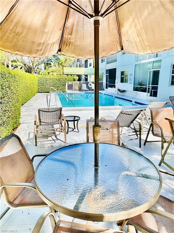 Community pool with a patio area and a gazebo