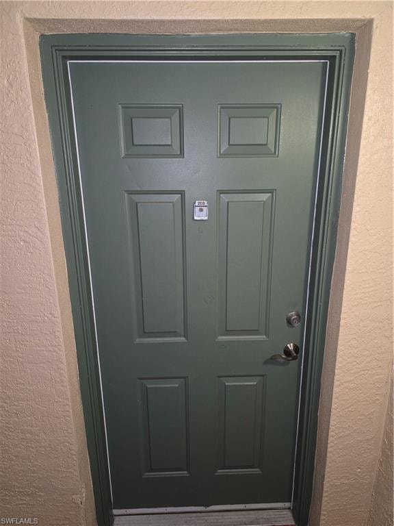 View of exterior entry with stucco siding
