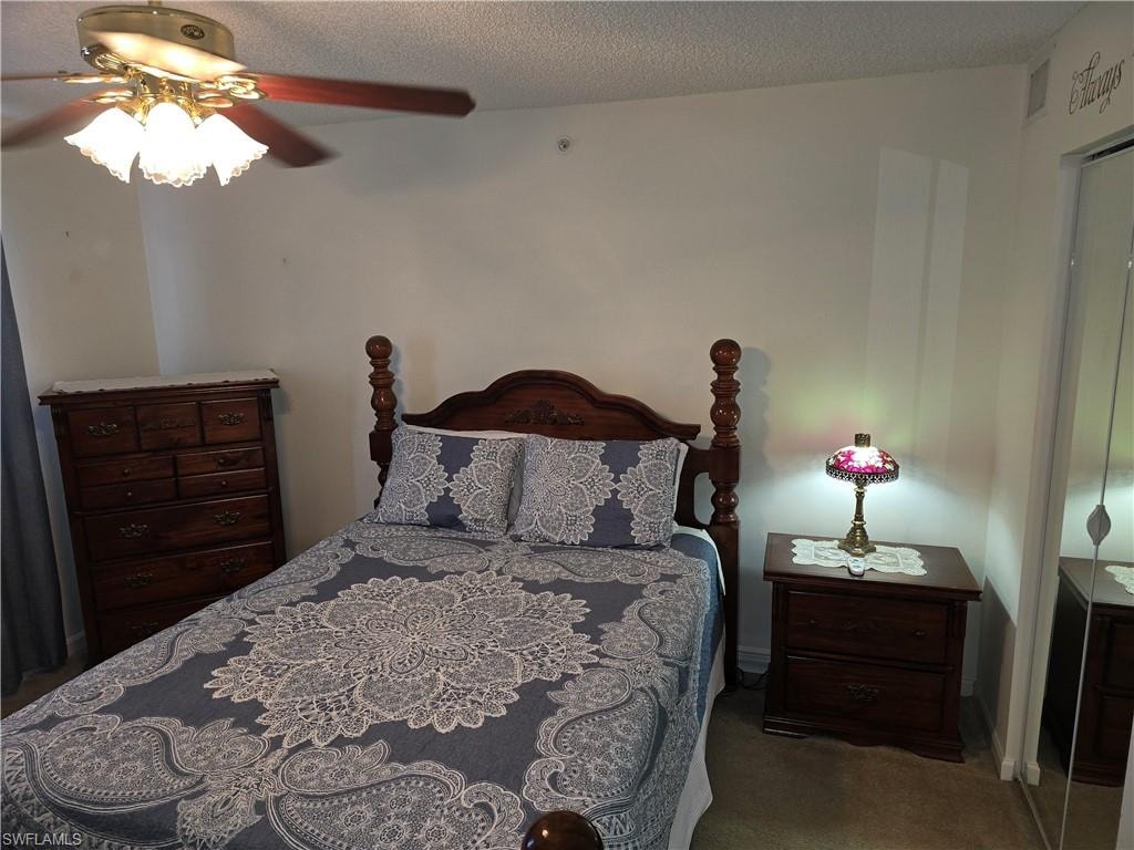 Bedroom with ceiling fan and carpet flooring