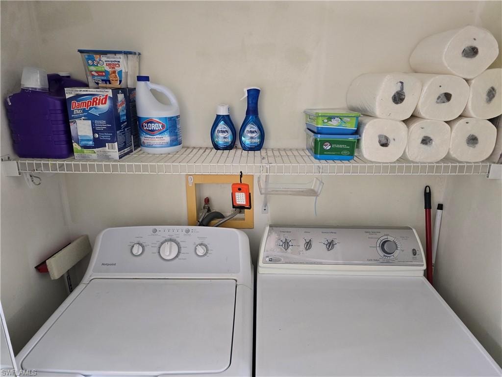 Washroom featuring laundry area and washer and clothes dryer