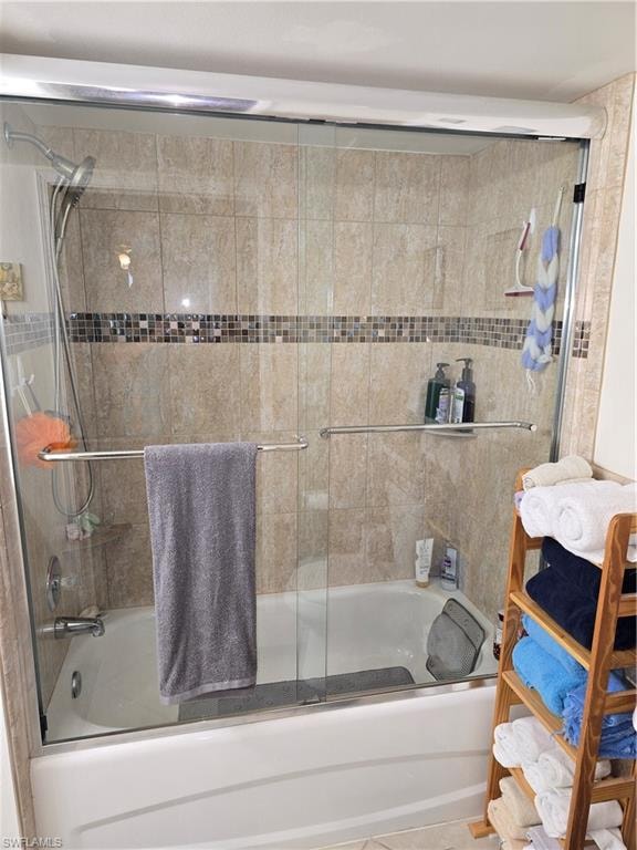 Bathroom with combined bath / shower with glass door