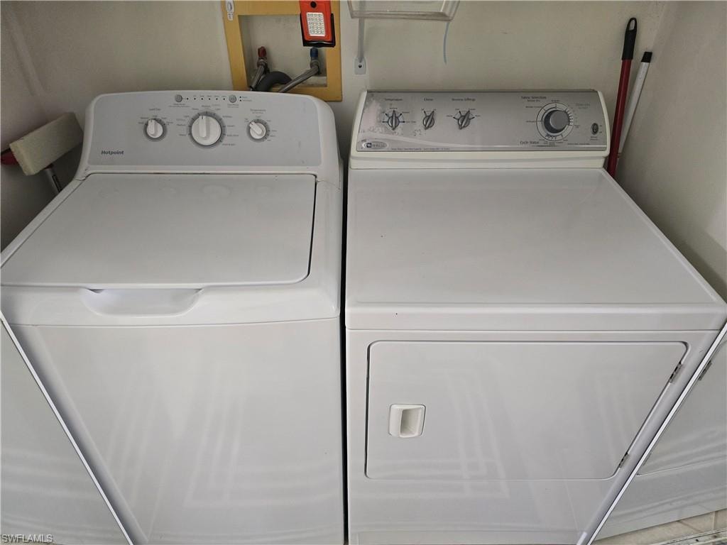 Laundry room with washing machine and clothes dryer