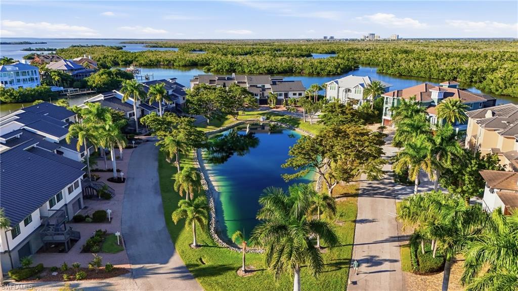 Aerial perspective of suburban area featuring a large body of water