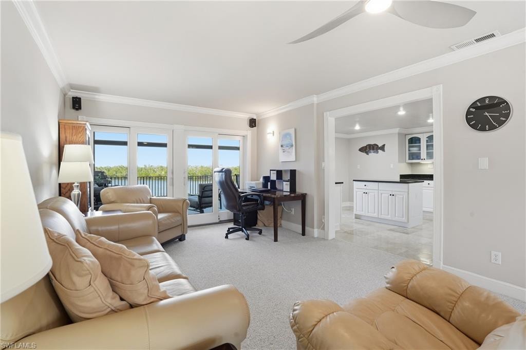 Office featuring crown molding, light colored carpet, and a ceiling fan