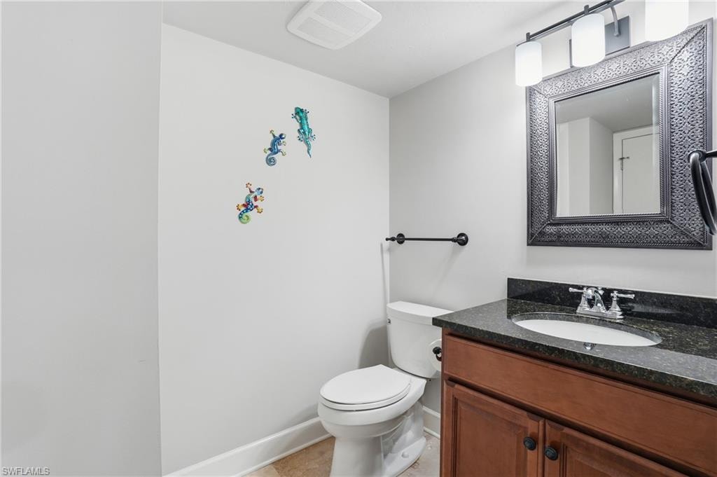 Half bath featuring vanity and toilet
