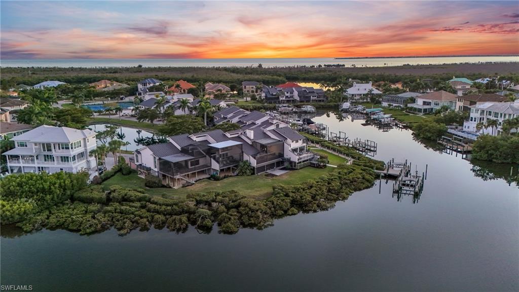 Aerial view of residential area featuring a nearby body of water