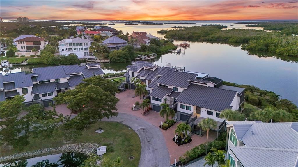 Aerial view at dusk of a water view and a residential view