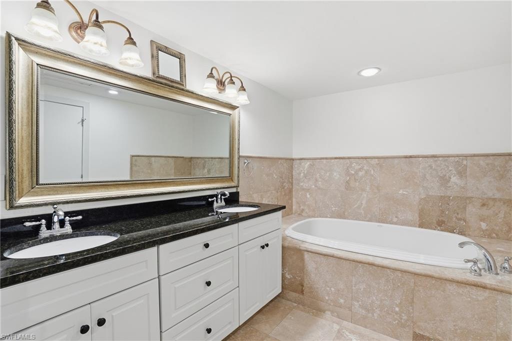 Full bath featuring double vanity, a garden tub, and recessed lighting