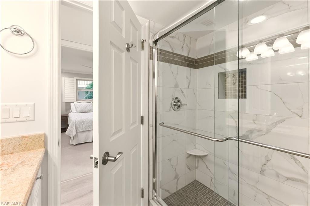 Bathroom with vanity, a tile finish shower.