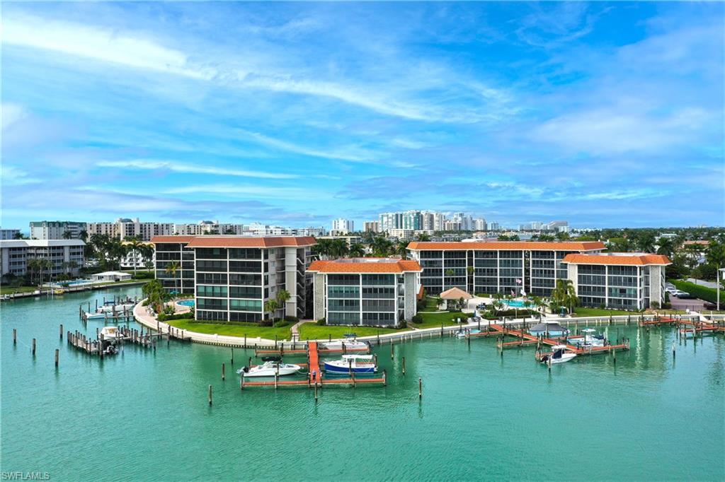 Water view with a boat dock and nearby urban area
