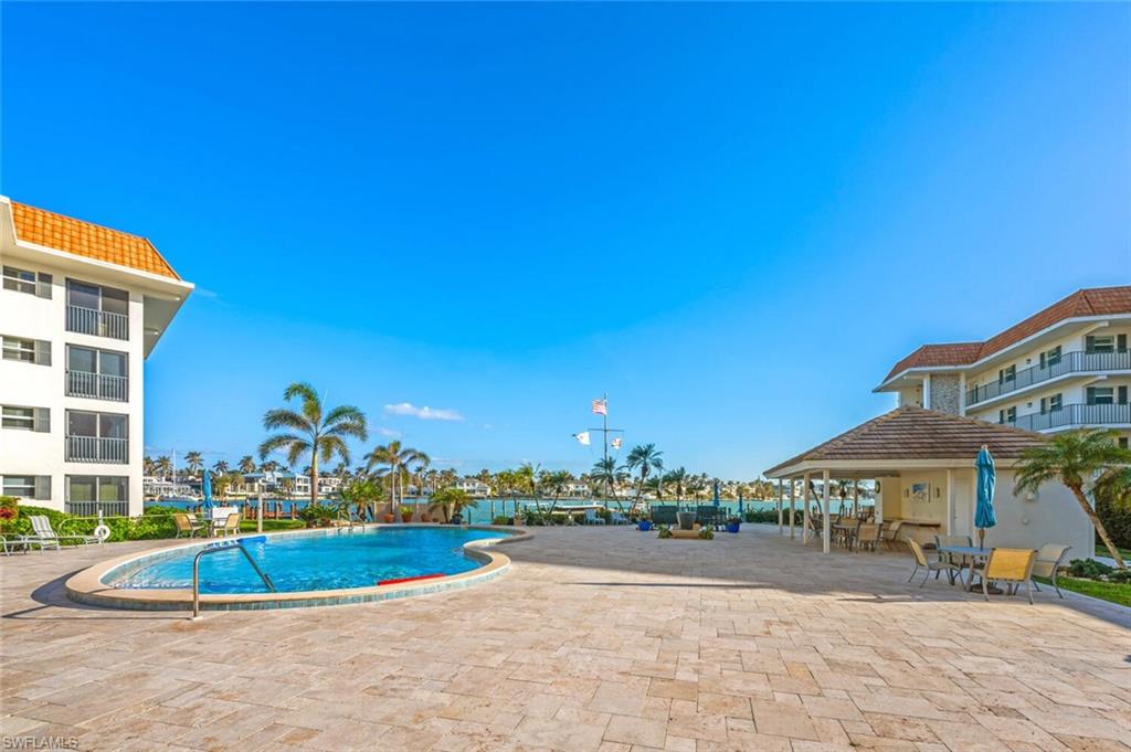 Community pool with a patio
