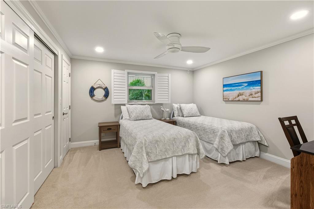 Bedroom with a closet, light carpet, crown     molding, ceiling fan, and recessed lighting