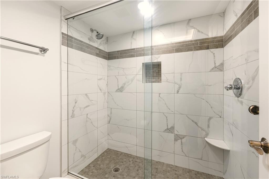 Full bath with a tile finish shower