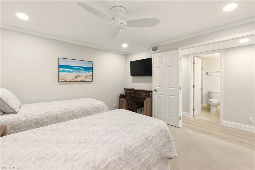 Bedroom with light carpet,crown molding, a ceiling fan, recessed lighting, hall bath