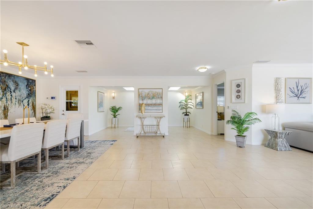 Dining area featuring crown molding and light tile patterned flooring