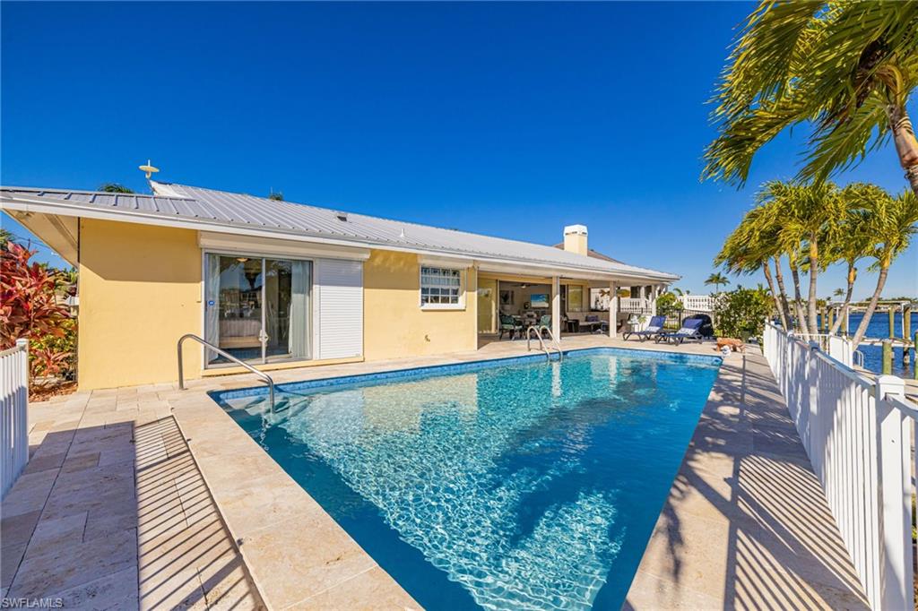 View of swimming pool with a patio area and a fenced backyard