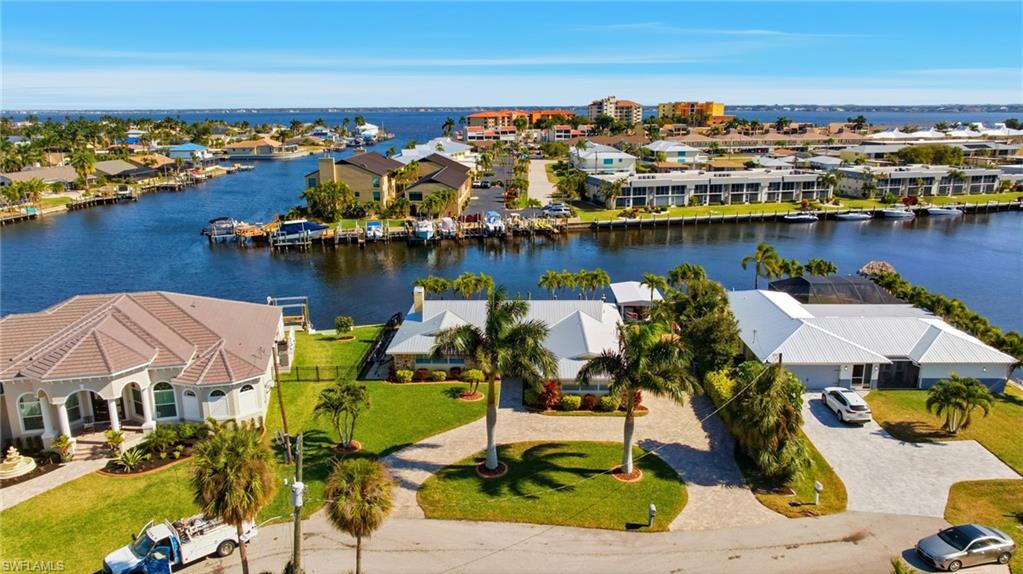 Aerial view of residential area featuring a nearby body of water