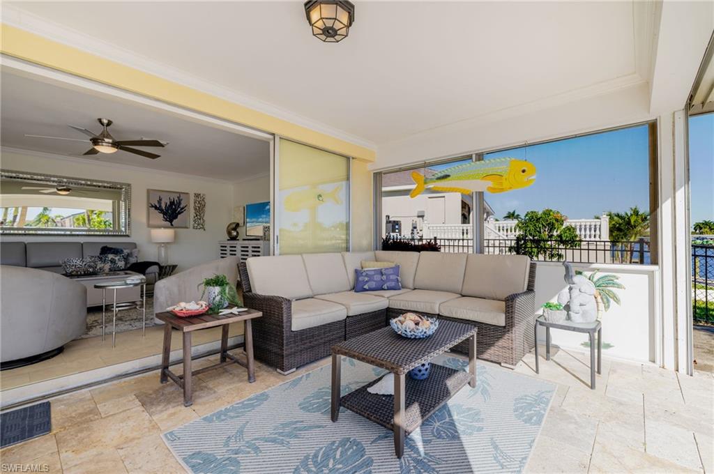 View of patio with an outdoor hangout area and ceiling fan