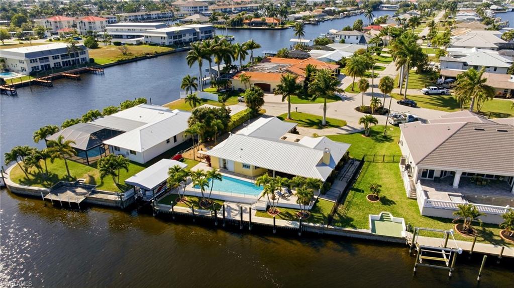 Aerial perspective of suburban area featuring a nearby body of water