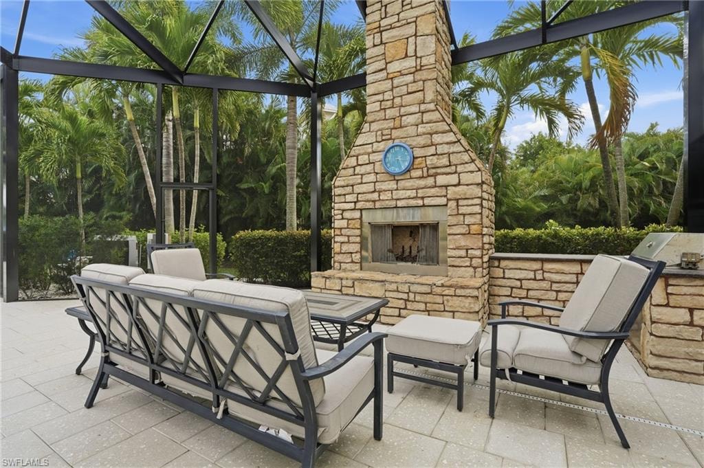 View of patio / terrace with an outdoor kitchen and an outdoor living space with a fireplace
