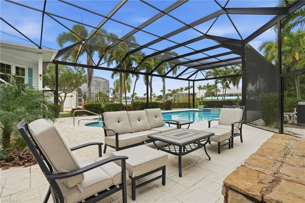 View of patio / terrace with a sunroom, an outdoor hangout area, and glass enclosure