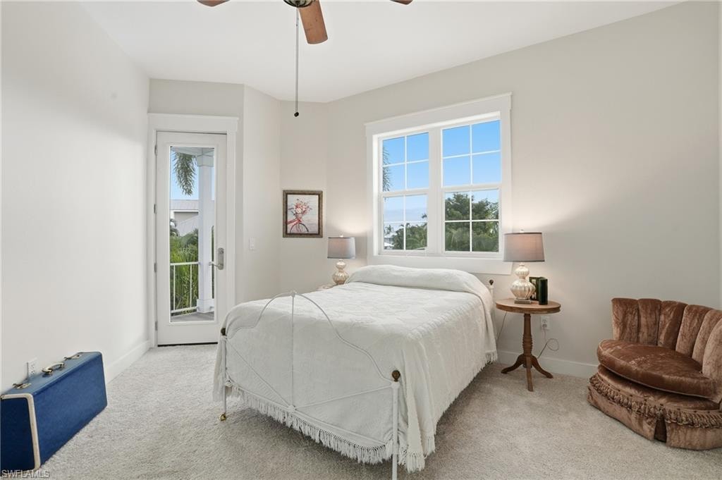 Carpeted bedroom with access to outside and a ceiling fan
