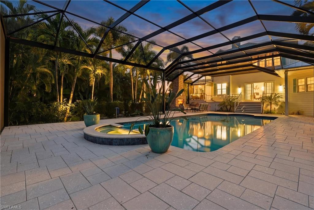 Integrated pool / spa with a lanai, a patio, and a sunroom