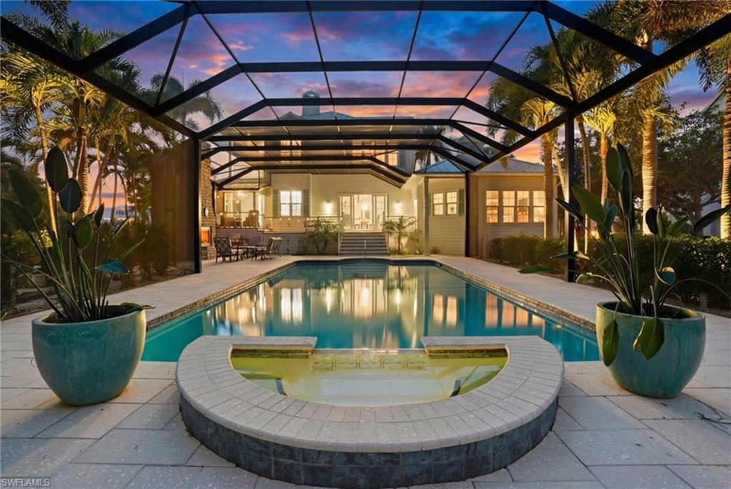 Integrated pool / hot tub featuring a sunroom, a patio area, and a lanai