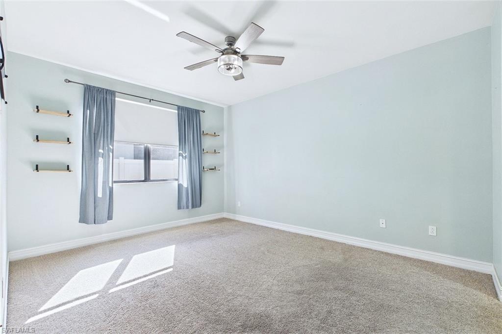 Empty room featuring carpet and a ceiling fan