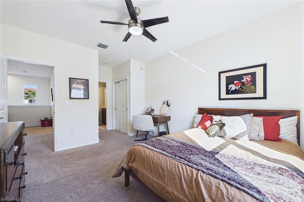 Bedroom featuring a closet, a ceiling fan, and carpet