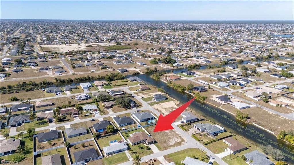 View of property location featuring nearby suburban area and a nearby body of water