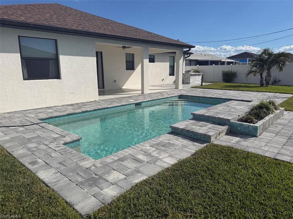 View of pool with a patio area and a fenced backyard