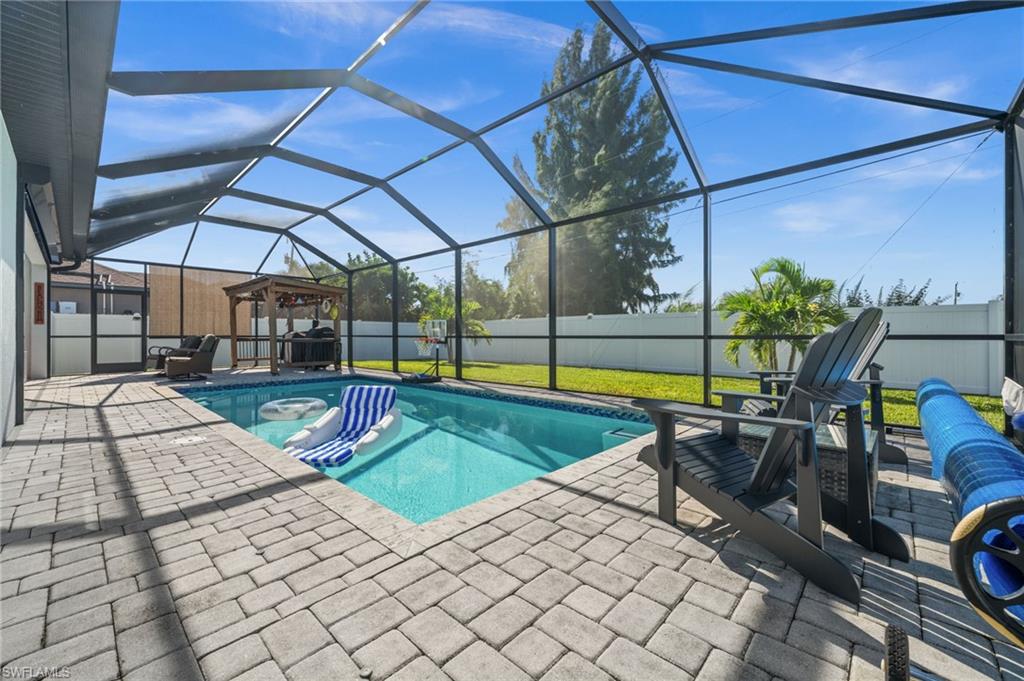 View of pool with a fenced backyard, a lanai, a sunroom, and a patio