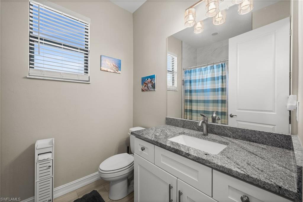 Full bath featuring a shower with curtain and vanity