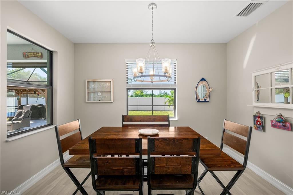 Dining space featuring a chandelier, healthy amount of natural light, and light wood-style floors