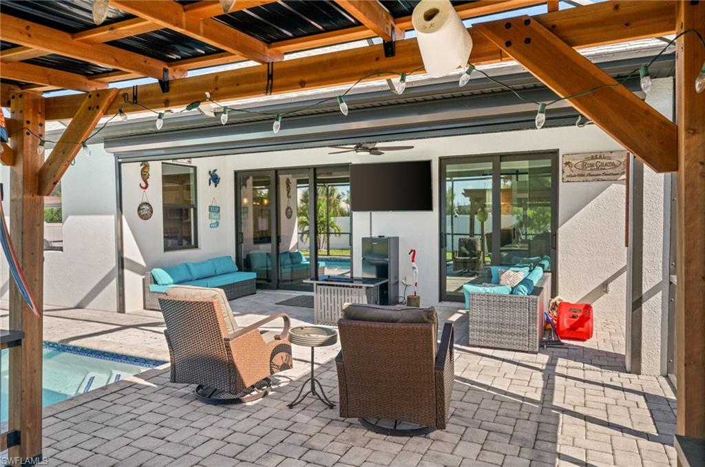 View of patio / terrace with outdoor lounge area, a ceiling fan, and an outdoor pool