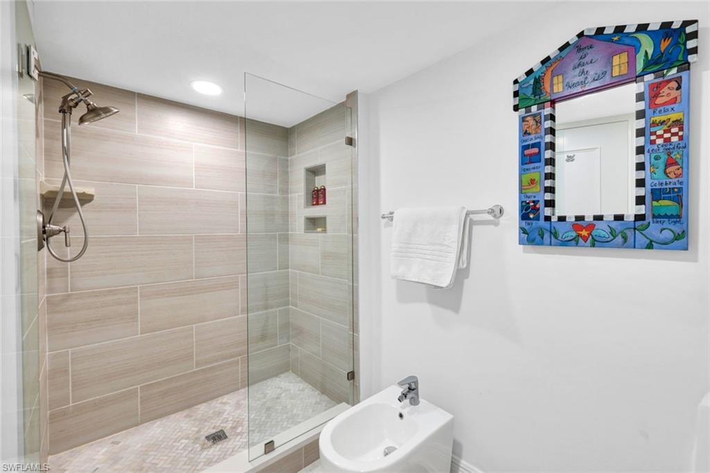 Bathroom with a bidet and an enclosed shower