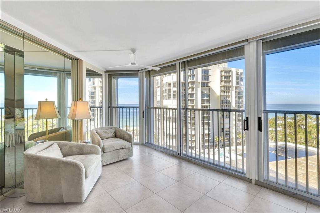 Sunroom / solarium featuring a water view